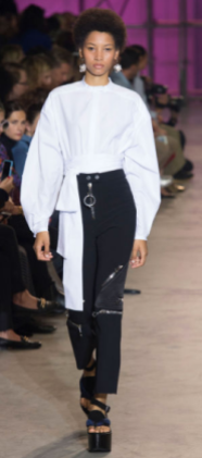 ELLERY The puffy white blouse compliments the dark lengthy pants with its metal details.