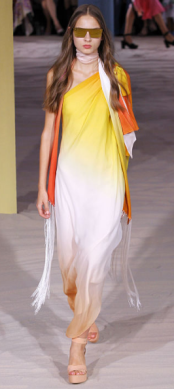 TEMPERLEY LONDON The use of bright colors encourages the warm tone of the lightly weighed design and the dangling fringe sets a balance for the one shoulder dress.